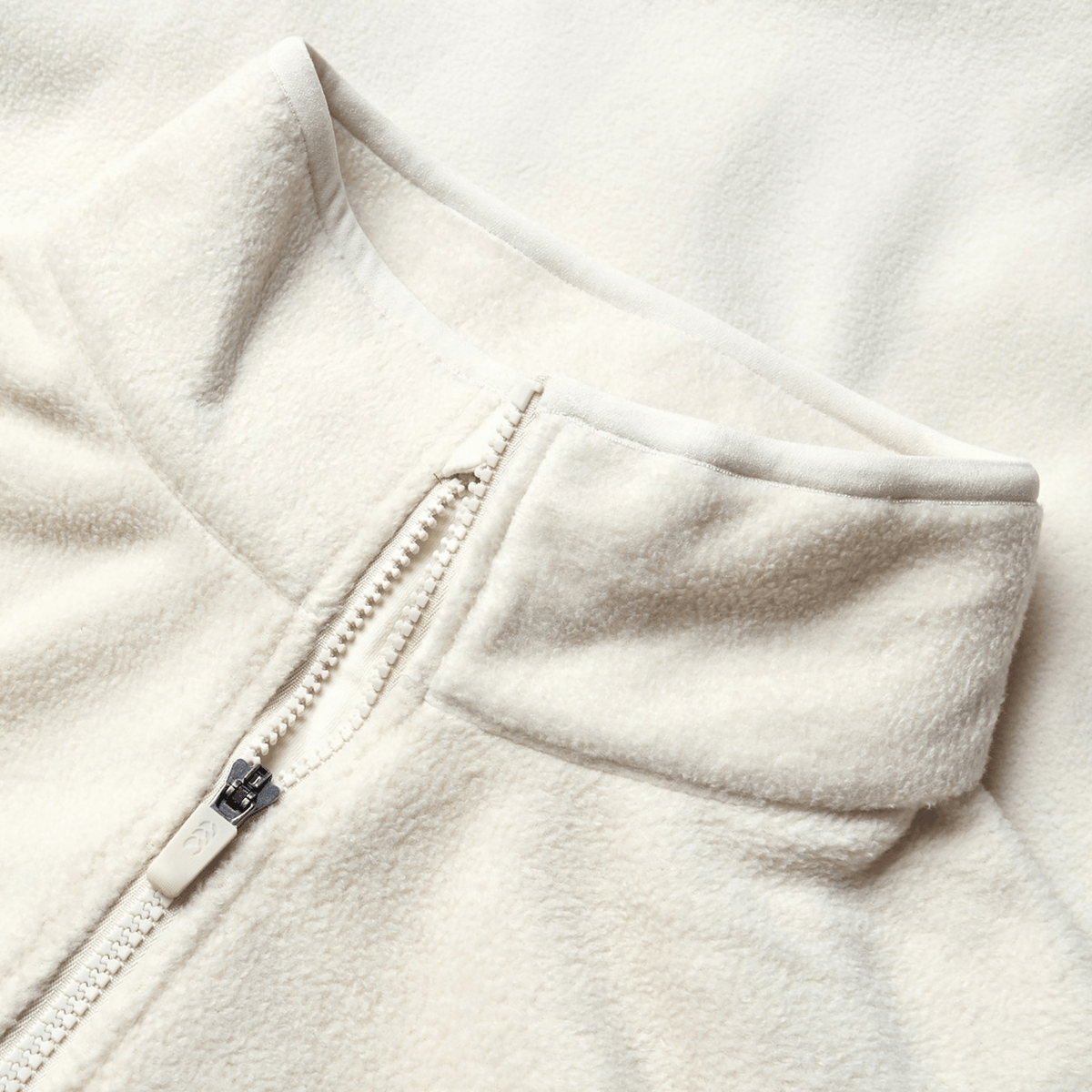 Close-up of the cream-colored British &amp; Irish Lions 2025 Outback Full-Zip Fleece Jacket by Canterbury, showcasing a stand collar and full-zip design, reflecting the classic style celebrated by the British &amp; Irish Lions.