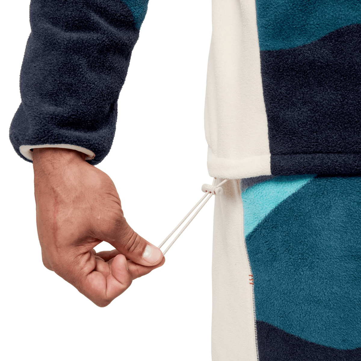 Close-up of a person pulling the drawstring on a blue and white jacket, evocative of the rugged style found in the British &amp; Irish Lions 2025 Outback Full-Zip Fleece Jacket by Canterbury.