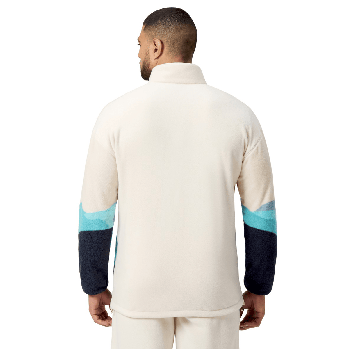 A person wearing the British &amp; Irish Lions 2025 Outback Full-Zip Fleece Jacket by Canterbury is shown from the back, highlighting its dark blue sleeves with light blue accents that embody the adventurous spirit of exploration.