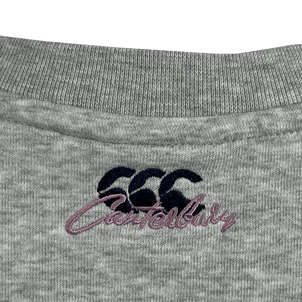 The relaxed fit Women&#39;s Canterbury Scene Set Crew Sweatshirt neckline showcases a blue &quot;CCC&quot; logo and &quot;Canterbury&quot; in purple script, with rib knit cuffs and hem enhancing its casual elegance.