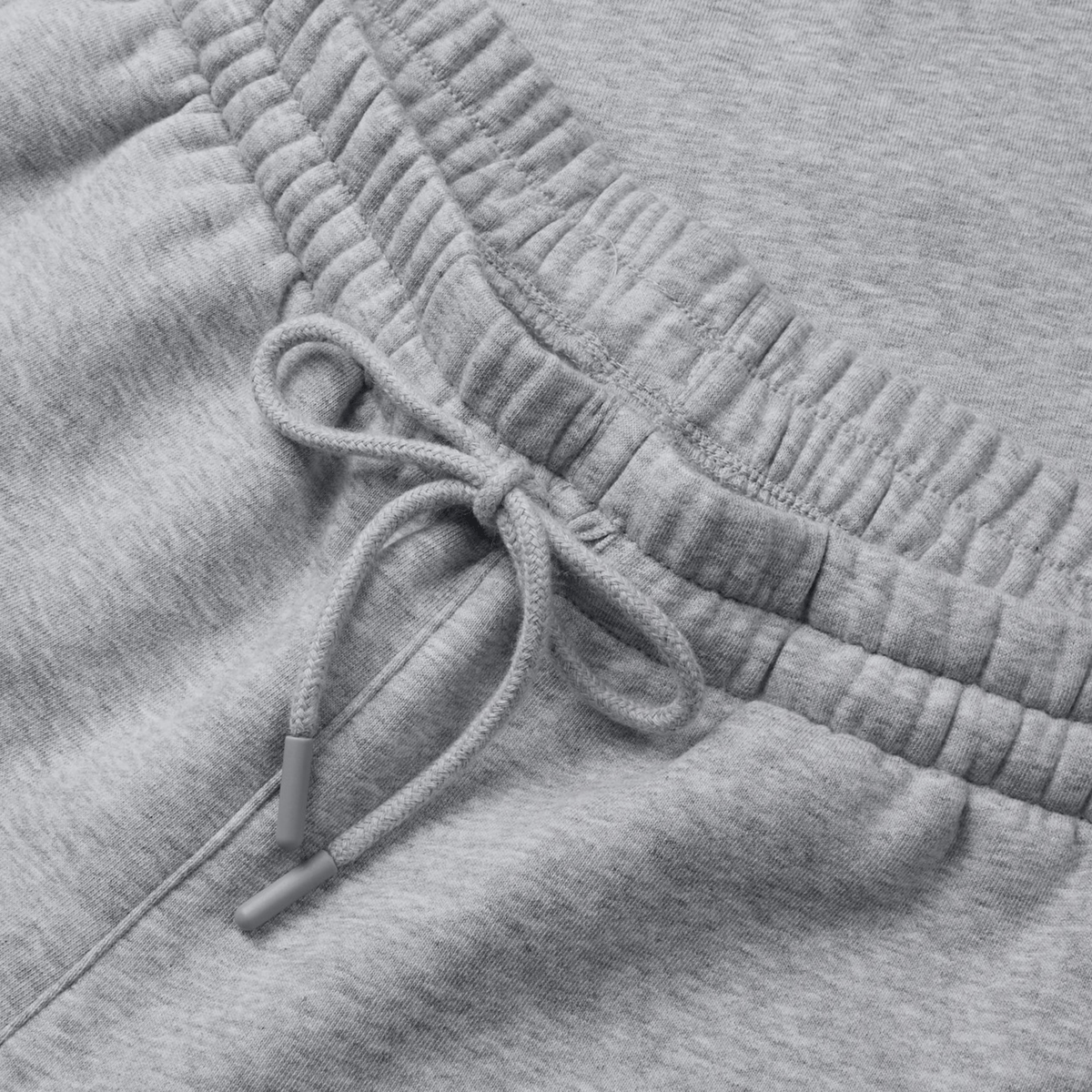 Close-up of Canterbury's Sport Dept Track Pant in grey, featuring an elastic waistband with a drawstring bow and cozy fleece lining.