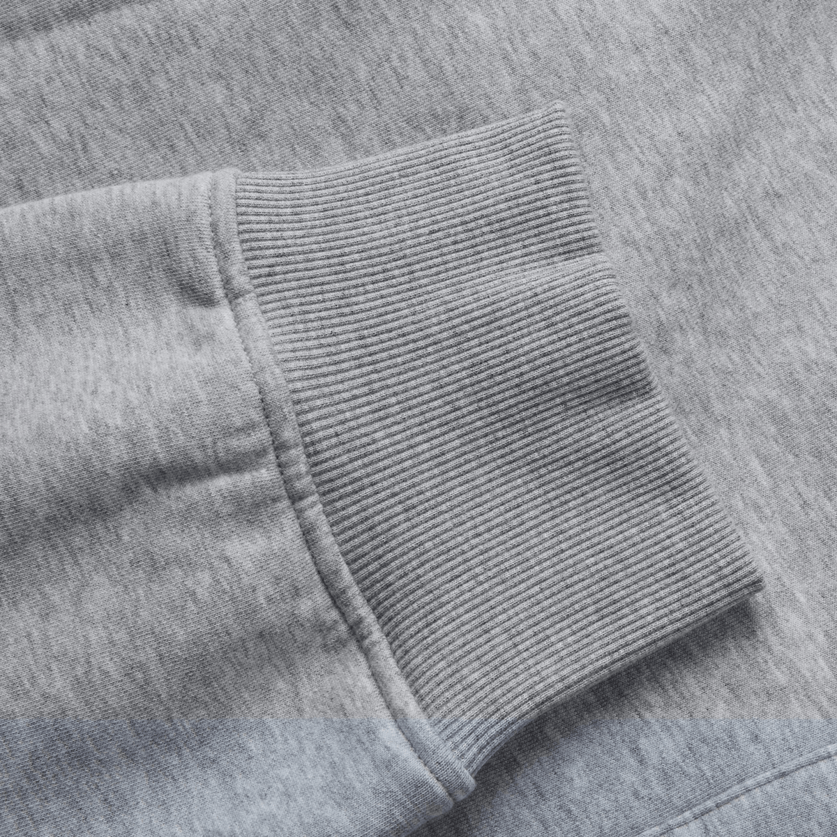 Close-up of the Canterbury Sport Dept Track Pant by Canterbury, featuring a gray fabric sleeve cuff with ribbed texture and stitching detail, similar to an elastic waistband.