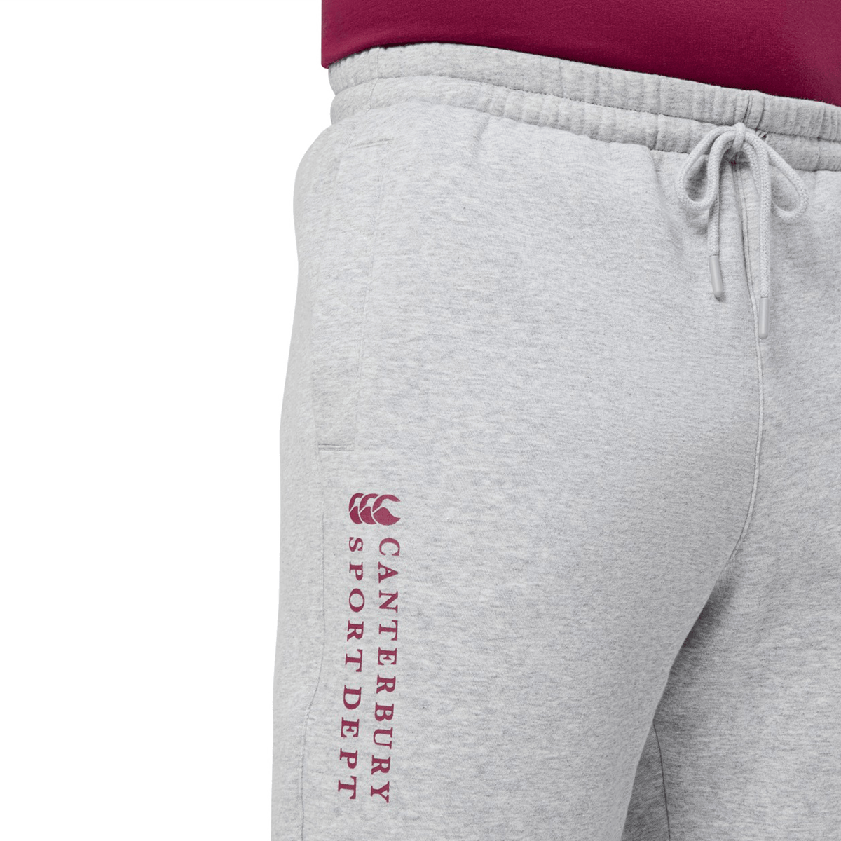 The Canterbury Sport Dept Track Pant by Canterbury is gray with "Canterbury Sport Dept" in maroon down the side. It features an elastic waistband with a drawstring, perfect for pairing with a maroon shirt for comfortable and stylish athletic wear.
