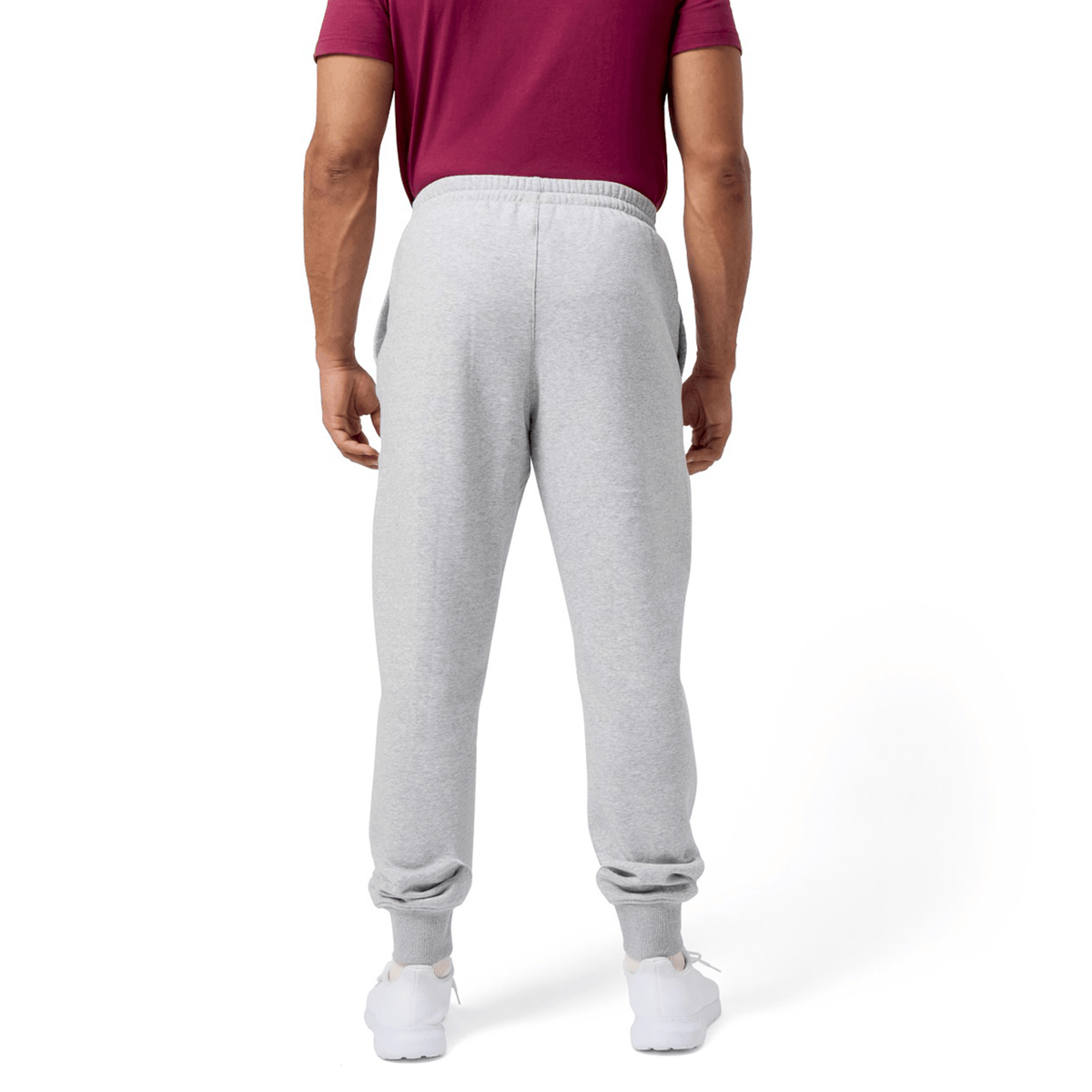 A person wearing a burgundy T-shirt and Canterbury's gray "Sport Dept Track Pant" with an elastic waistband, standing with their back to the camera.