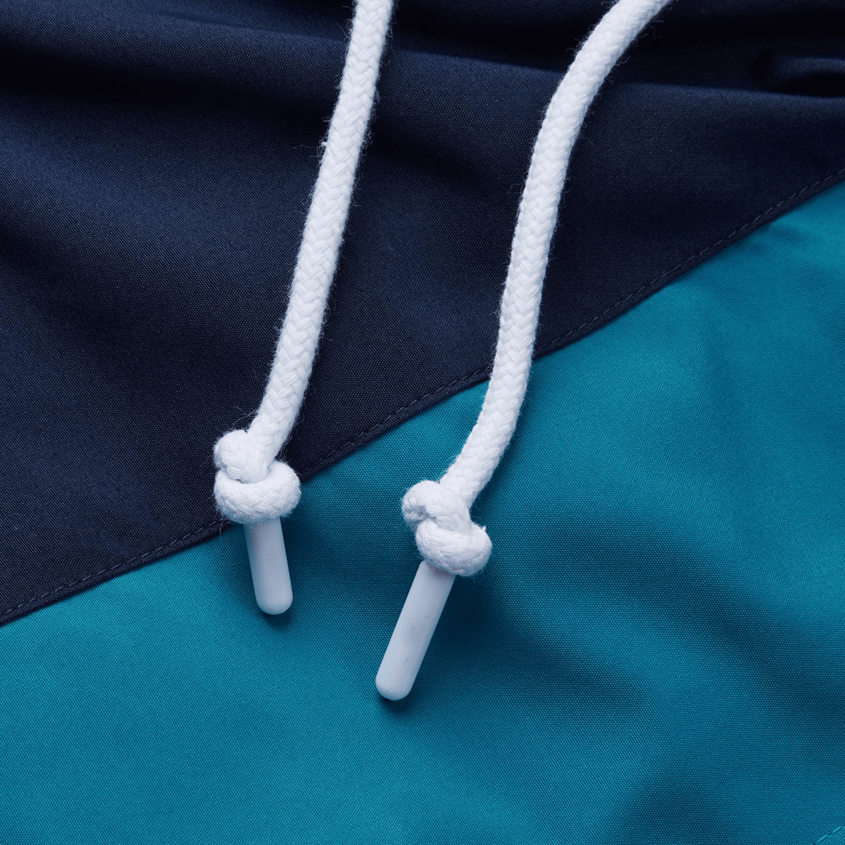 The Canterbury Harlequin Legends Trackpant features intricate blue and teal fabric, two white drawstrings with knotted plastic tips—an essential for any rugby enthusiast's wardrobe.