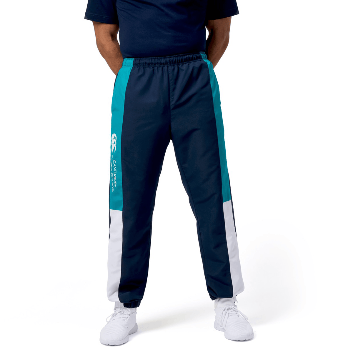 A must-have for rugby fans, the Canterbury Harlequin Legends Trackpant in navy and teal is ideal for both the field and casual wear. When paired with white shoes on a plain white background, they exude a sporty yet stylish appearance.