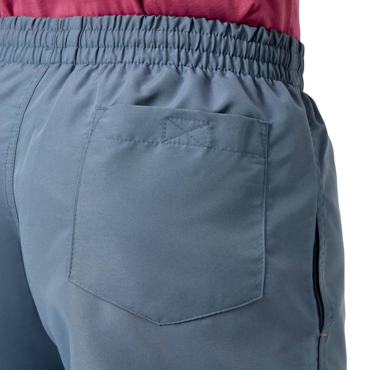 Close-up of someone wearing the Women&#39;s Canterbury Uglies 5&quot; Tactic Short in blue polyester with an elastic waistband and back pocket, paired with a red top, echoing the vibrant style of Canterbury Uglies collections.