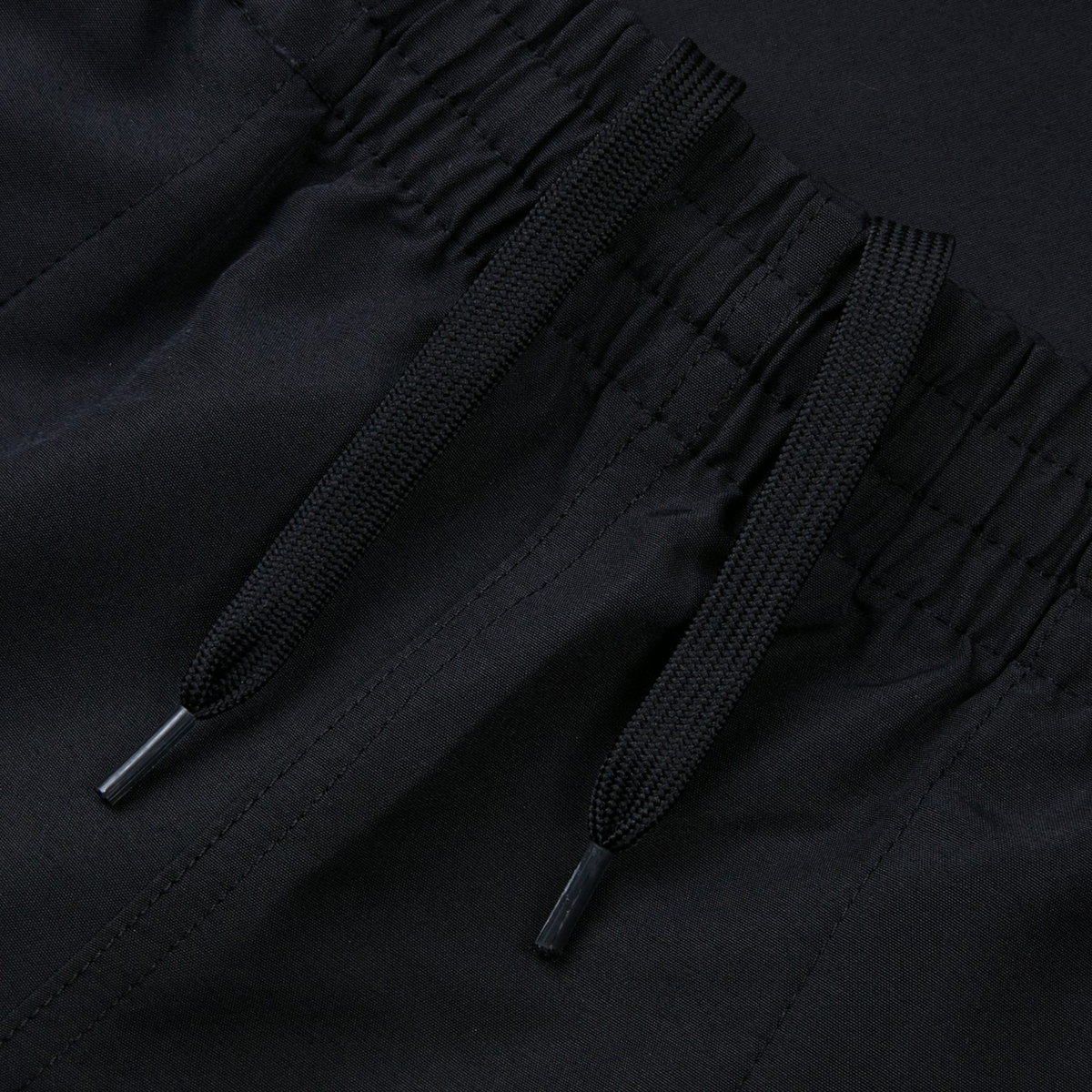 Close-up of Women&#39;s Canterbury Uglies 5&quot; Tactic Short in black, featuring a drawstring and elastic waistband, made from smooth polyester fabric.