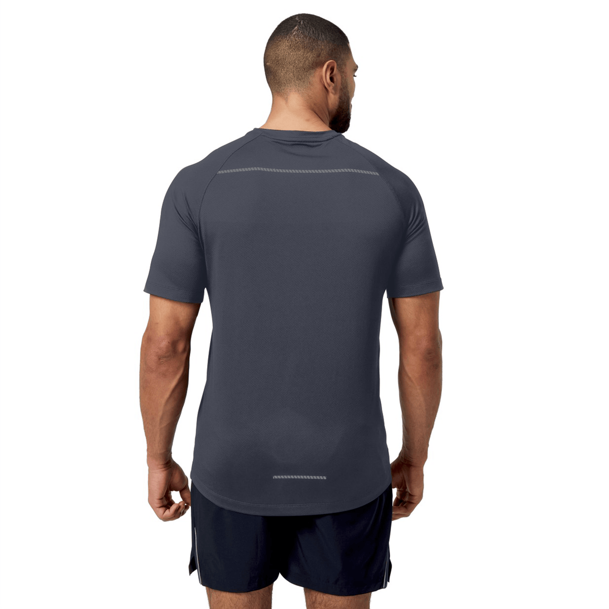 Man wearing a Canterbury Tempo+ Training Tee in black sports shirt and shorts, made from moisture-wicking fabric, with his back to the camera.