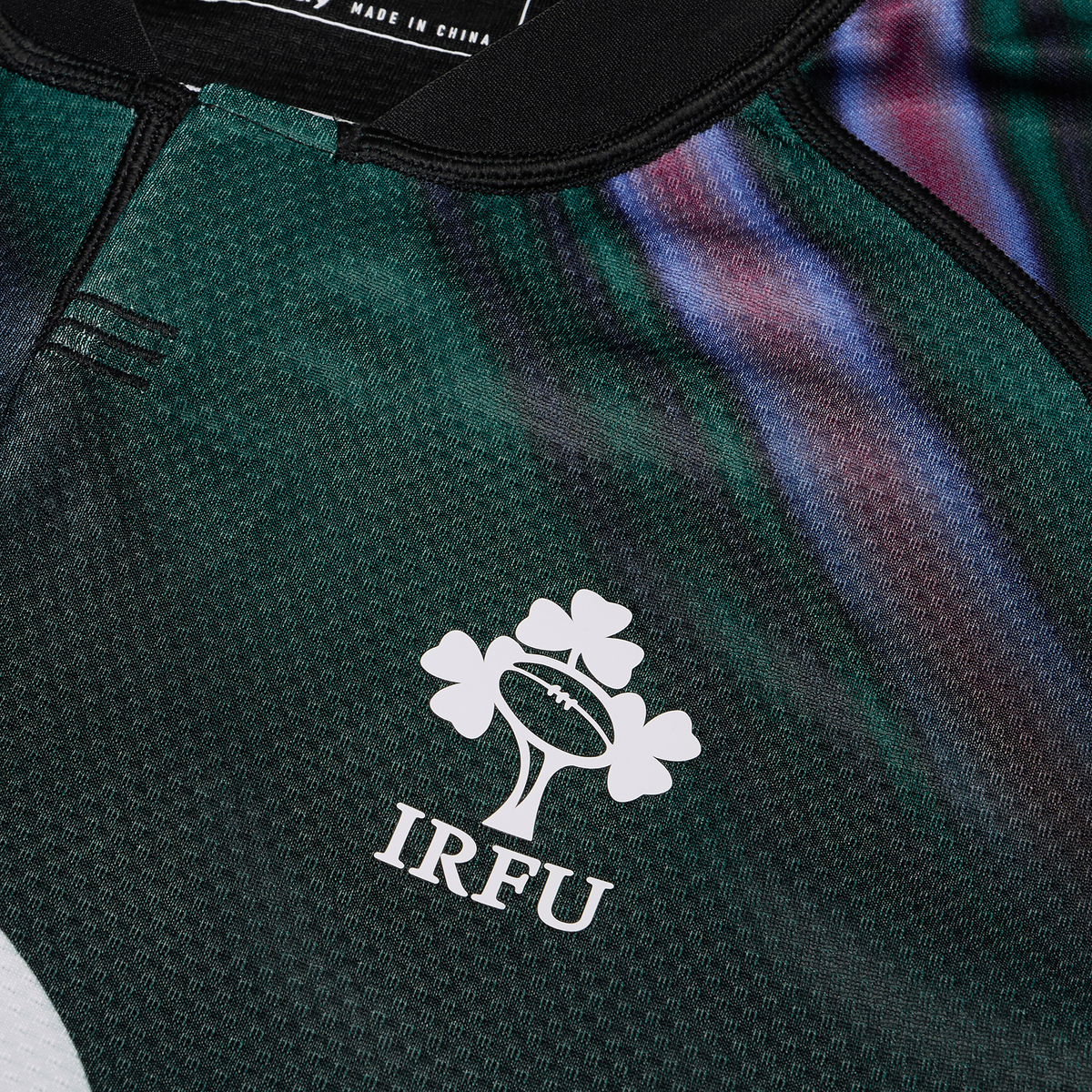 Close-up of the Ireland 25/26 Pre Game Pro Jersey by Canterbury, showcasing the IRFU logo with a rugby ball and three shamrocks, crafted in Canterbury’s Vapodri fabric for ultimate comfort.