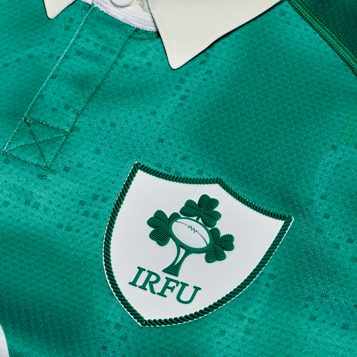 Close-up of the Canterbury Ireland 25/26 Home Test Jersey featuring the IRFU crest with its iconic shamrock and rugby ball emblem—a must-have green jersey for Ireland rugby fans and players.