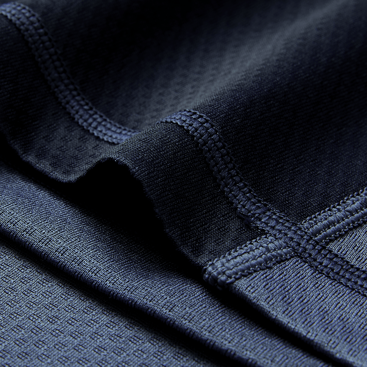 Close-up of the Ireland 26/27 Summer Tour "Indigo" Training Test Jersey by Canterbury, showing dark blue athletic fabric with visible stitching and texture, emphasizing its premium quality.