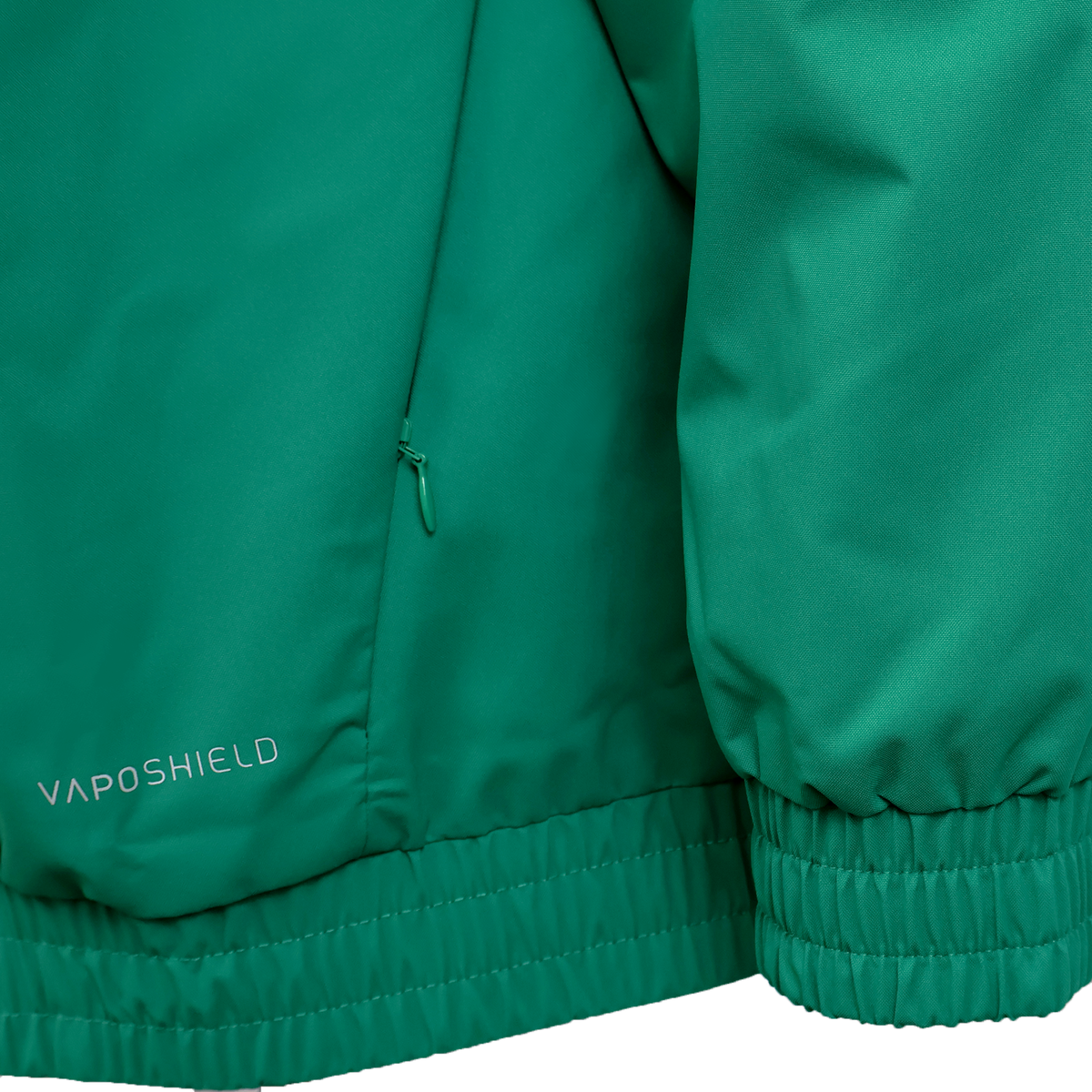 Close-up of the Ireland 25/26 Anthem Jacket by Canterbury, showing a visible pocket zipper, ribbed hem and cuffs, and &quot;VapoShield&quot; printed near the bottom.