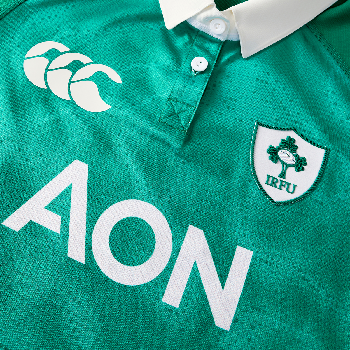 The Women&#39;s Ireland WIRFU 25/26 Pro Home Jersey by Canterbury features a white collar, CCC logo, AON sponsor, and IRFU shamrock crest—ideal for fans seeking the official women&#39;s home rugby jersey.