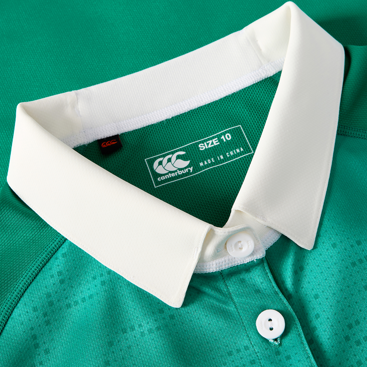 Close-up of the Women&#39;s Ireland 25/26 Home Pro Jersey by Canterbury, showing a white collar, two white buttons, and a size 10 label with &quot;made in China.