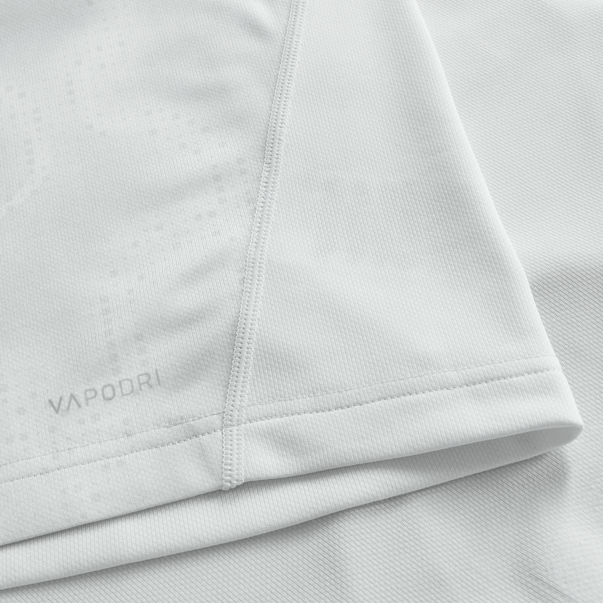 Close-up of a white athletic shirt with visible stitching and "VAPODRI" near the hem, highlighting the quality of the Ireland 25/26 Alternate Pro Jersey by Canterbury.