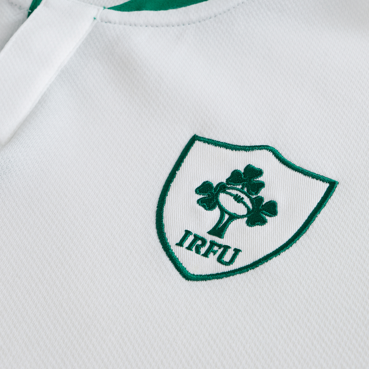 Close-up of the Ireland 25/26 Long Sleeve Classic Alternate Jersey by Canterbury, showcasing the green IRFU logo with shamrock and rugby ball emblem.