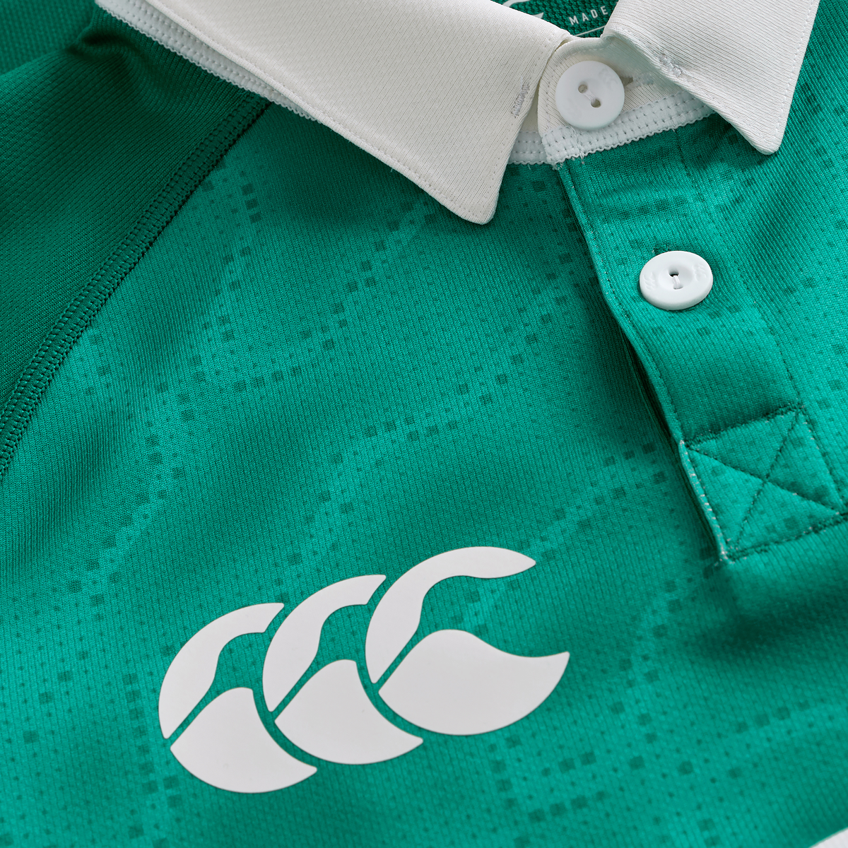 Close-up of the Youth Ireland 25/26 Home Pro Jersey by Canterbury in green, with a white collar, buttons, and the iconic Canterbury logo on the chest.