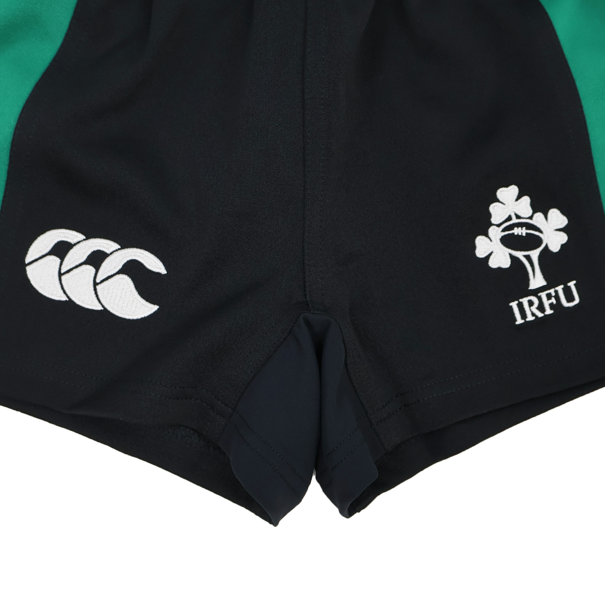 Close-up of the Youth Ireland 25/26 Alternate Match Short by Canterbury, featuring the Canterbury logo on the left and IRFU shamrock on the right. These official alternate shorts blend style and performance for young rugby players.