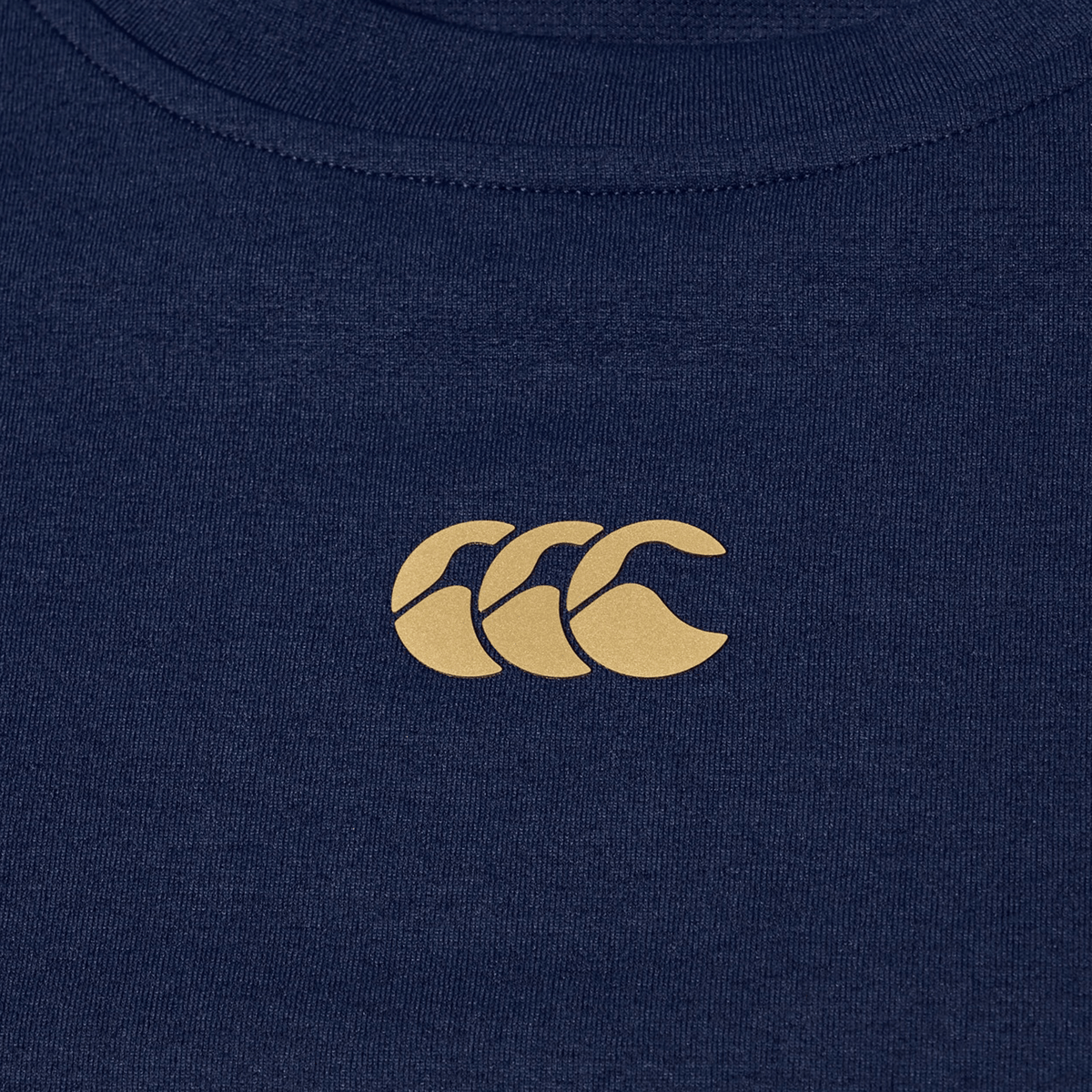 The Canterbury Everest Dart Tech T-Shirt is a navy blue, quick-drying tech tee with a small light brown "CCC" logo centered on the chest.