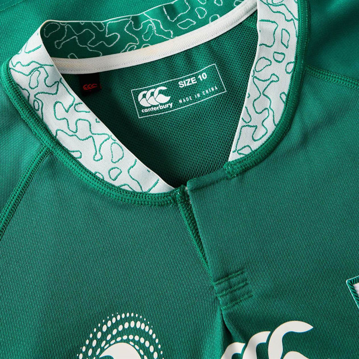 Close-up of the Women&#39;s Ireland WRWC25 Replica Home Jersey by Canterbury, size 10, in green with a patterned white collar and visible brand and size labels.
