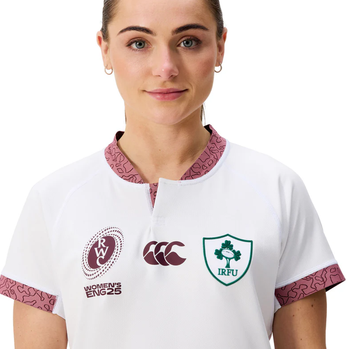Someone wearing the Women&#39;s Ireland WRWC25 Replica Alternate Jersey by Canterbury, featuring the IRFU emblem, 2025 WRWC alternate branding, and Canterbury&#39;s logo on the front.