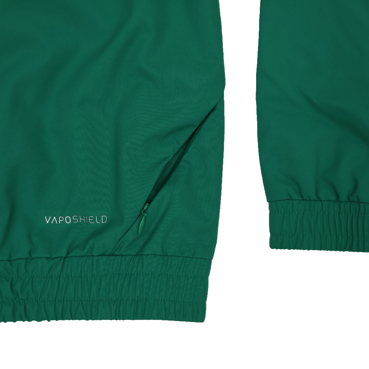 Close-up of the Youth Ireland 25/26 Anthem Track Jacket by Canterbury in green, showing elastic cuffs, a zippered pocket, and &quot;VAPOSHIELD&quot; printed near the pocket.