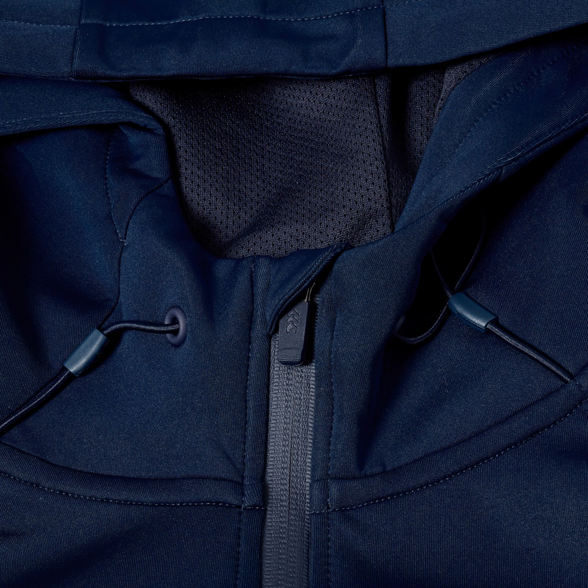 Close-up of a navy blue Canterbury Everest Full Zip Hoodie by Canterbury, highlighting the zipper, drawstrings, and part of the hood with mesh lining.