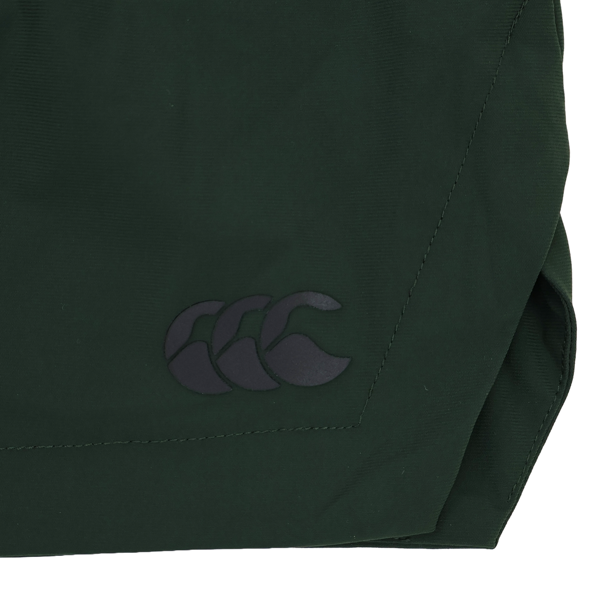 Close-up of a dark green four-way stretch fabric used in the Canterbury Everest Woven Short 5", featuring a black Canterbury logo with three overlapping curved shapes.