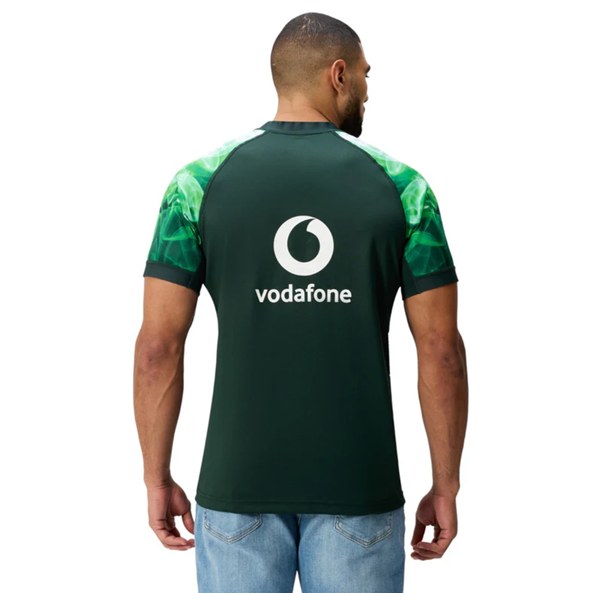 A man wearing a green Limited Edition Ireland "Chicago" Pro Pre-Game Jersey by Canterbury with the Vodafone logo on the back stands facing away from the camera.