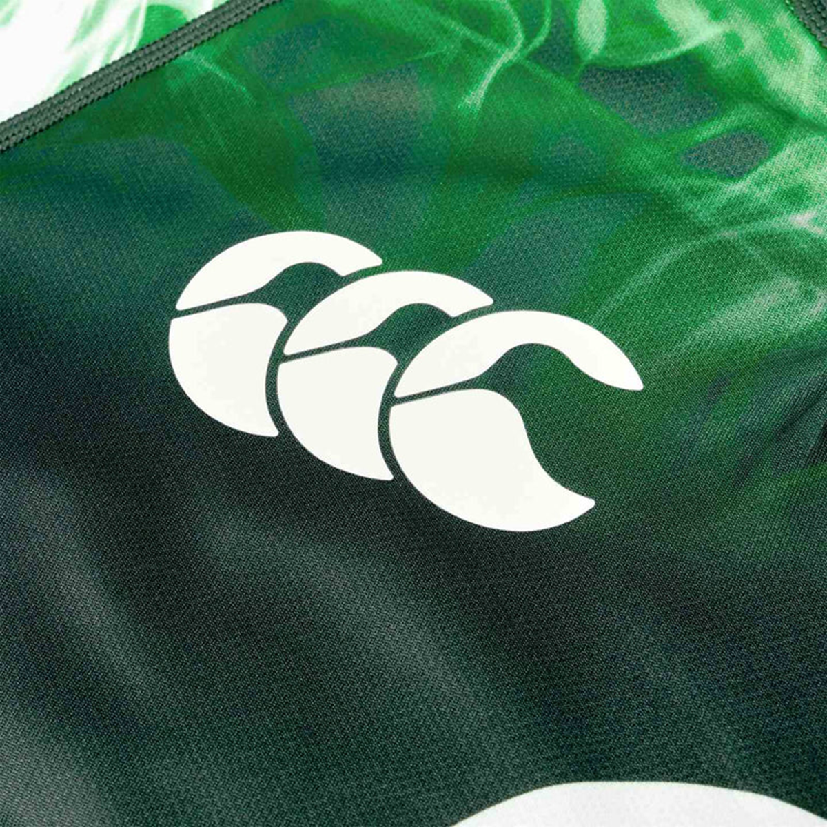 Close-up of the Limited Edition Ireland "Chicago" Pro Pre-Game Jersey by Canterbury in green, featuring a white Canterbury logo and VapoDri technology for enhanced comfort.