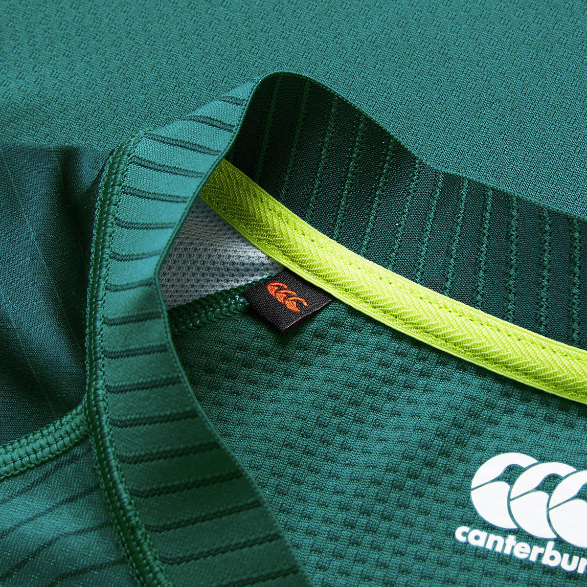 Close-up of the Ireland 26 Home Test Jersey by Canterbury, highlighting its green textured fabric, a visible inner tag, and the white Canterbury logo on the lower right.