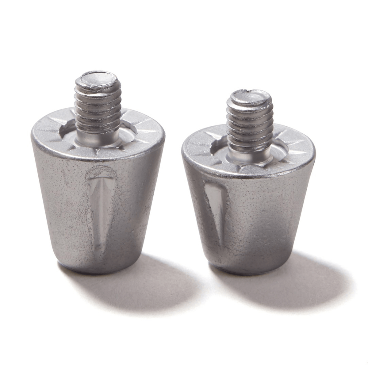 Two upright Canterbury Short Performance Studs from Canterbury, featuring a cylindrical metallic design with a textured surface, perfect for use as aluminum studs on soft ground boots, are displayed against a white background.