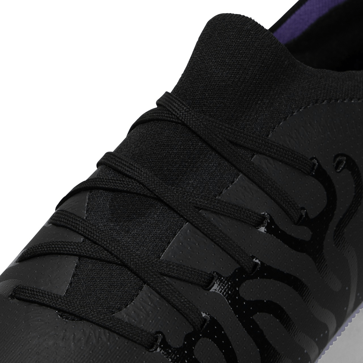 Close-up of a black sports shoe with textured design details, designed for kicking accuracy, known as the Canterbury Speed Infinite Pro SG - Black/Verbena.
