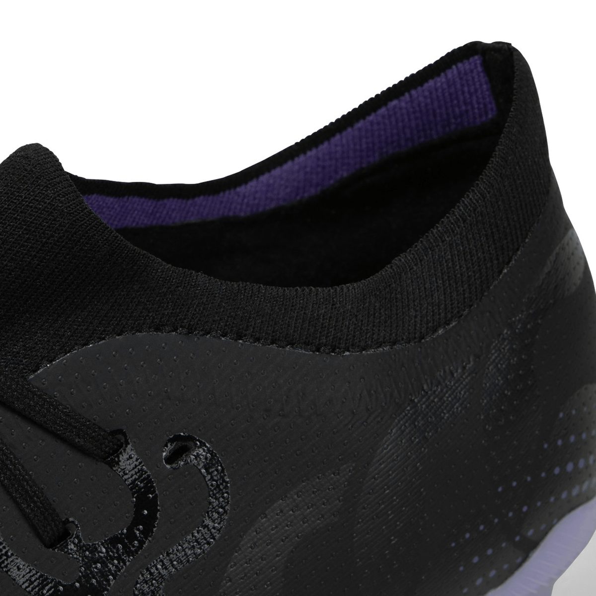 Close-up of a black, lightweight boot with purple interior lining, known as Canterbury Speed Infinite Pro SG - Black/Verbena.