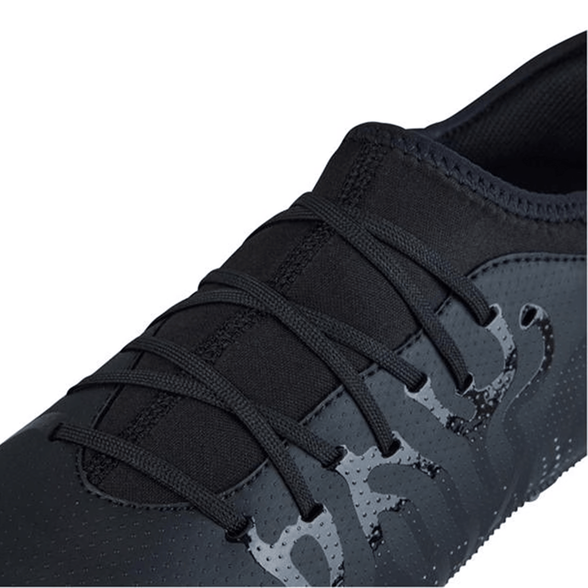 Close-up view of the Canterbury Speed Infinite Team SG - Black/Silver Metallic sneaker, showcasing a sleek design with black laces and an abstract glossy pattern near the laces, epitomizing speed and agility.