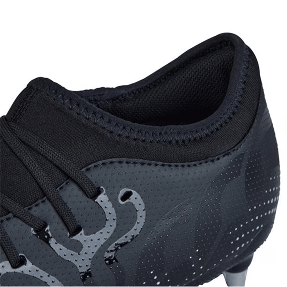 Close-up of a Canterbury Speed Infinite Team SG soccer cleat in Black/Silver Metallic, showcasing intricate gray patterns, complete with laces, a neoprene collar, and a studded sole that emphasize its lightweight construction.