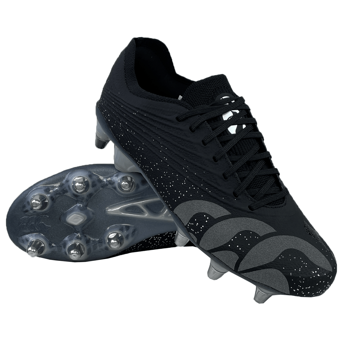 A pair of Canterbury Stampede Groundbreak Elite SG Cleats in black with silver metallic accents and a dotted pattern. One cleat is lying on its side, showing the sole with multiple studs, perfectly compatible with the WRS M5 Stud Kit for easy replacement.