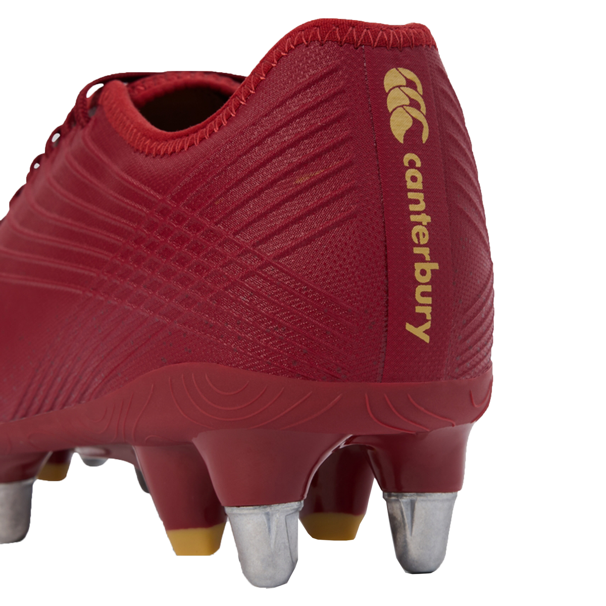 Close-up of the heel of the Canterbury Stampede Groundbreak Pro SG - Red Dahlia by Canterbury, a soft ground rugby boot featuring metal studs and yellow branding for optimal performance.