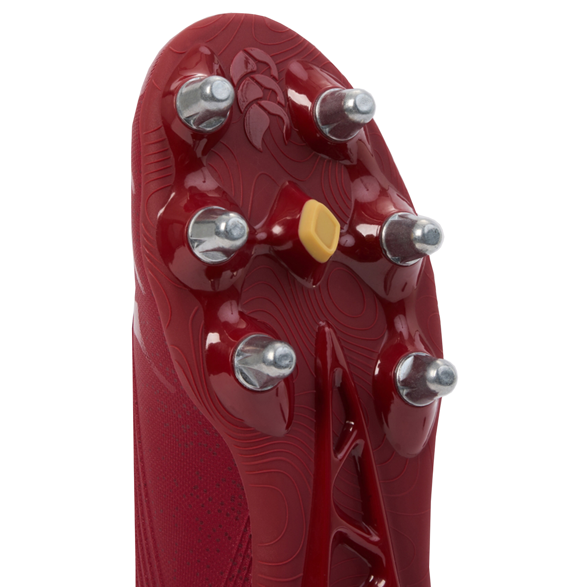Close-up of the sole of the Canterbury Stampede Groundbreak Pro SG - Red Dahlia boot by Canterbury, featuring six metal studs and a central yellow detail.