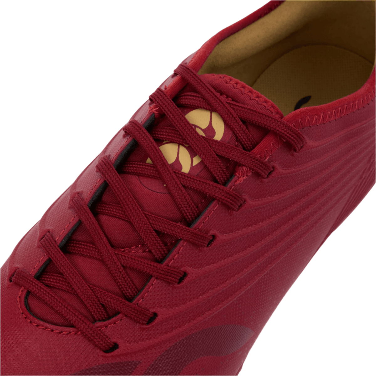 Close-up of the Canterbury Stampede Groundbreak Pro SG - Red Dahlia by Canterbury, featuring red laces, a tan insole, premium soft ground rugby boot style, detailed stitching, and curved patterns.