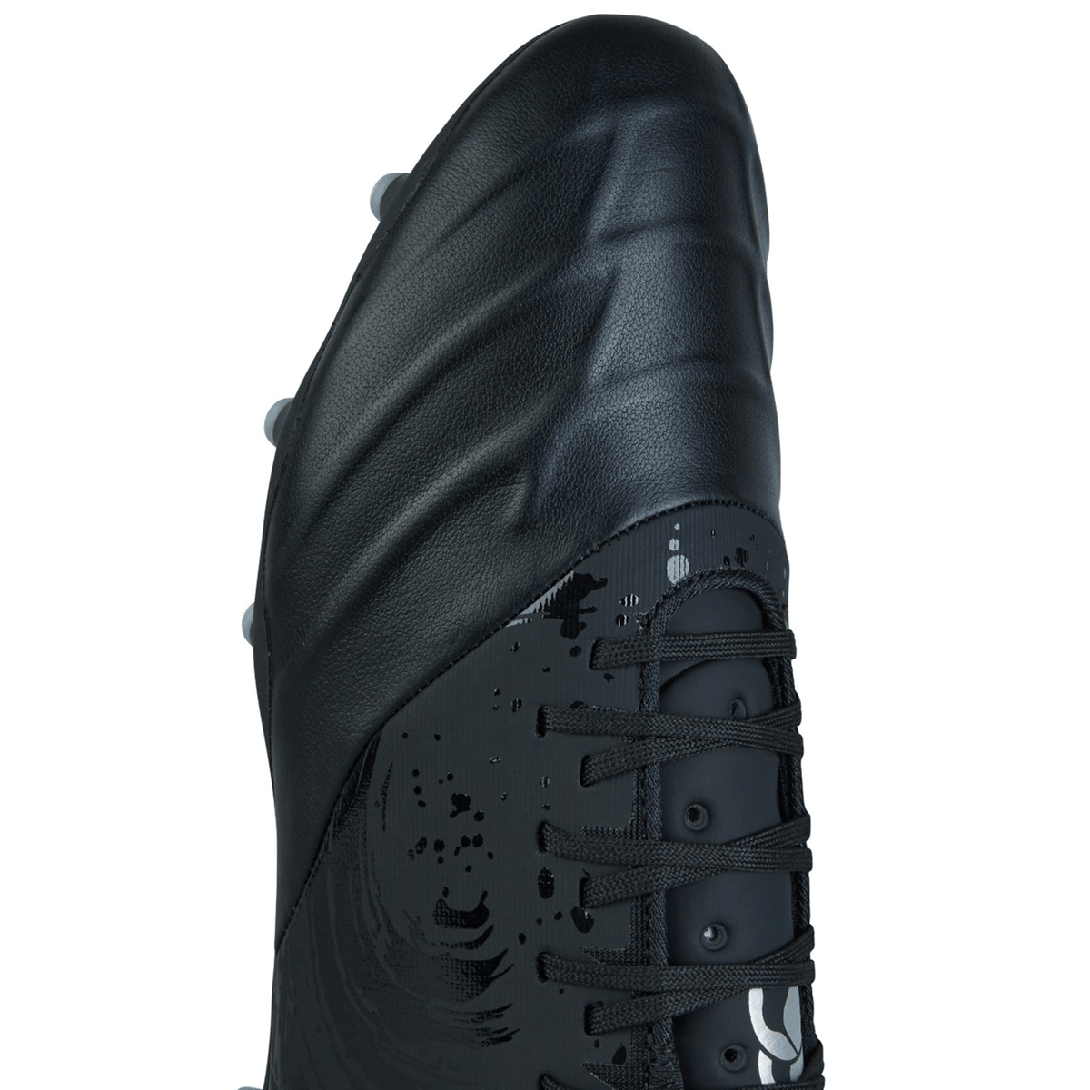 Close-up image of the Canterbury Phoenix Genesis Pro FG black and silver metallic soccer cleat, highlighting its TPU-reinforced mesh upper surface, lace closure, and studded outsole designed for firm-ground grip on the field.