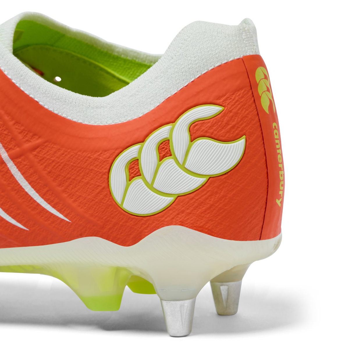 Close-up of the heel of the Canterbury Phoenix 2.0 Elite SG rugby boot in Tangerine Tango/Snow White, showing metal studs and Canterbury branding.