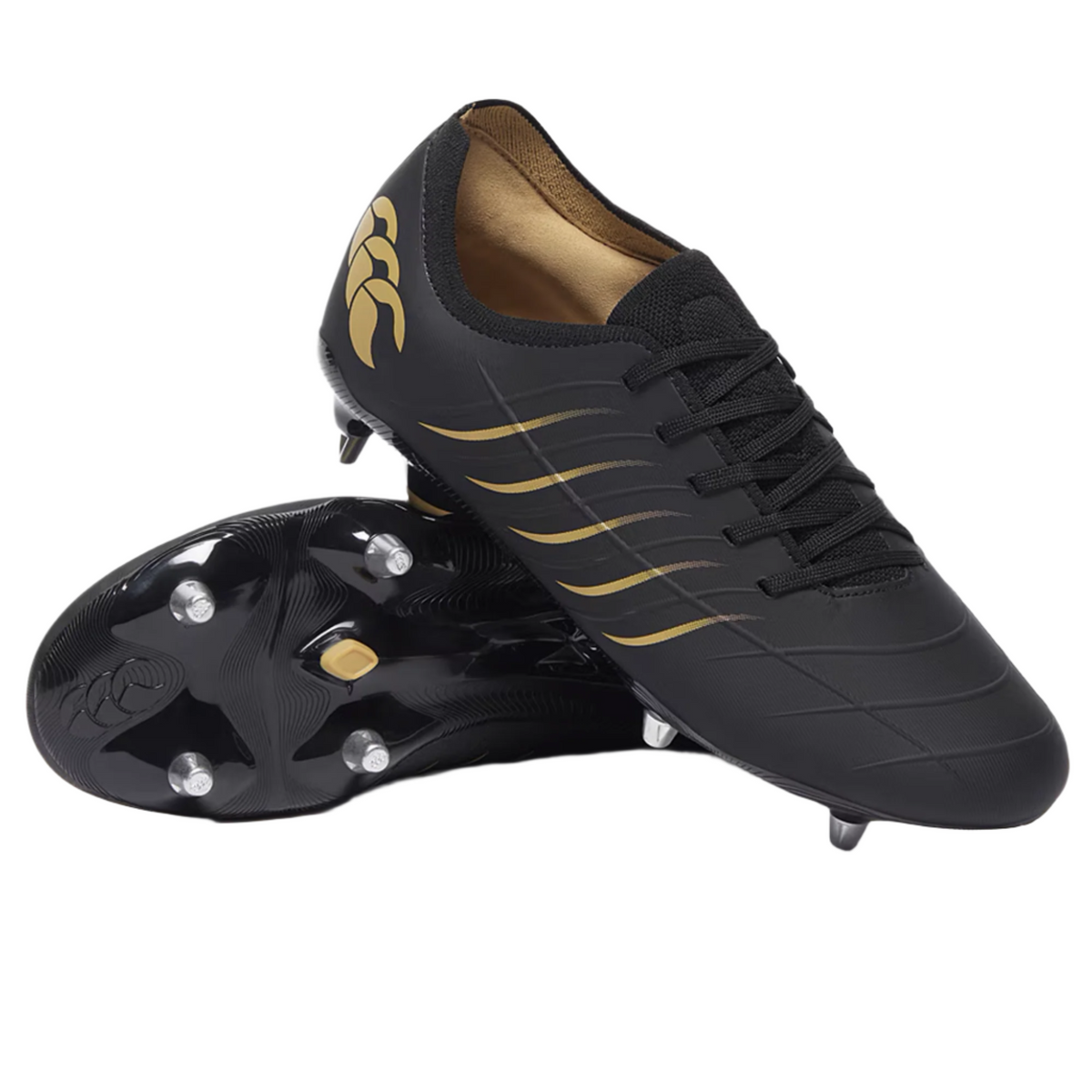 A pair of Canterbury Phoenix 2.0 Pro SG rugby boots in black with gold accents—one upright, one on its side displaying the metal soft ground studs.