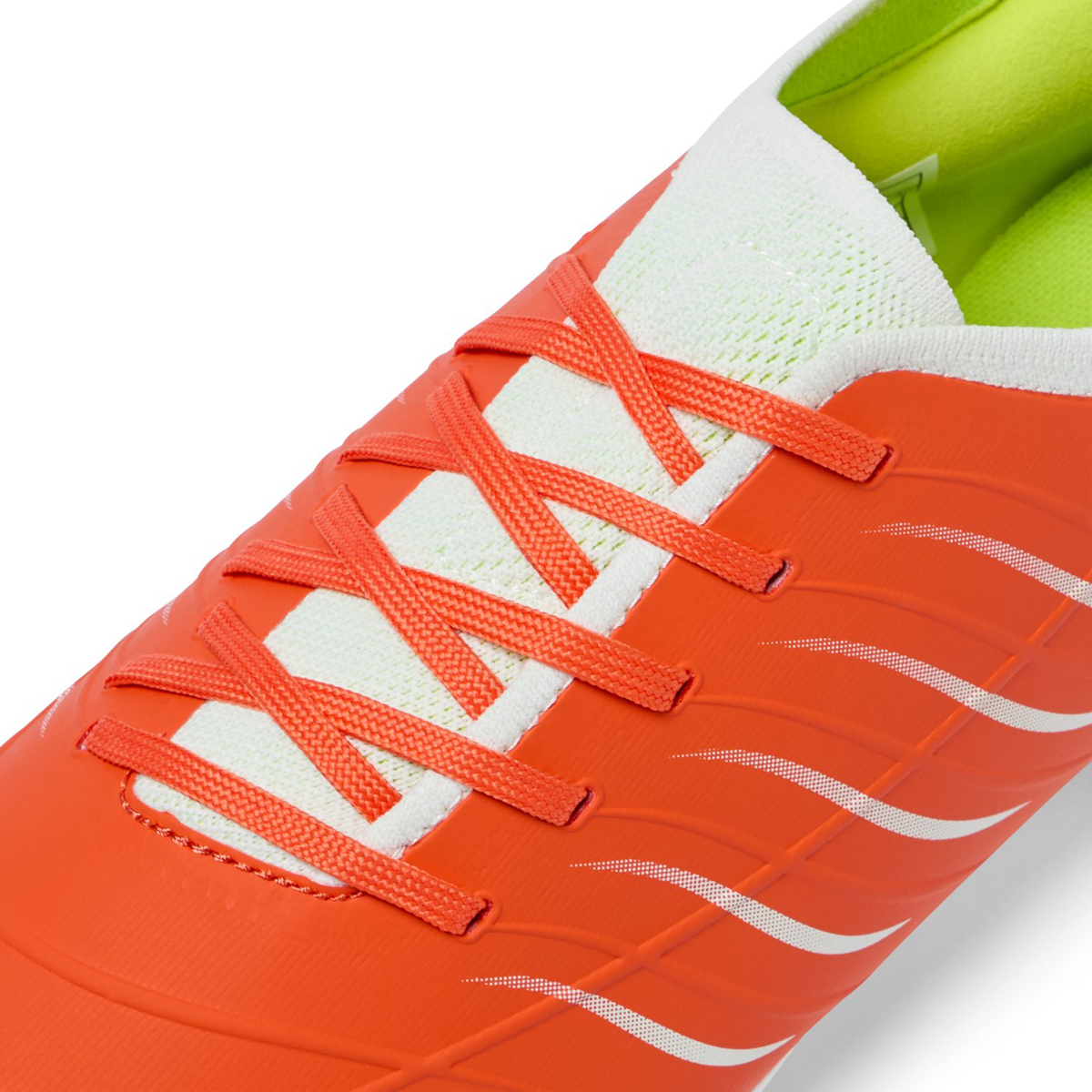 Close-up of the Canterbury Phoenix 2.0 Pro FG in Tangerine Tango/Snow White by Canterbury, featuring white and orange laces, wavy side designs, and a light green interior lining.