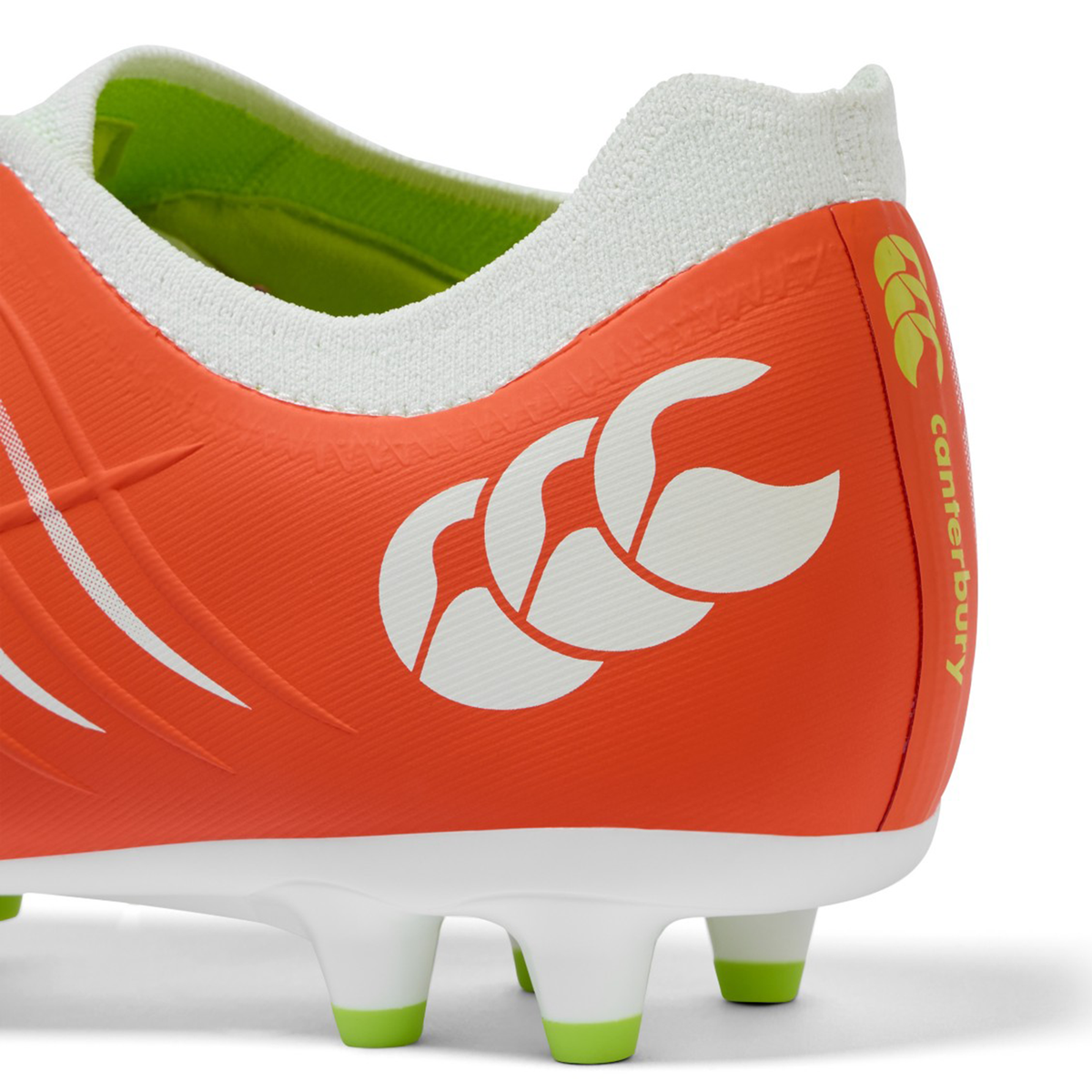 Close-up of the heel on the Canterbury Phoenix 2.0 Pro FG - Tangerine Tango/Snow White rugby boot, showing the white Canterbury logo and green-tipped studs.