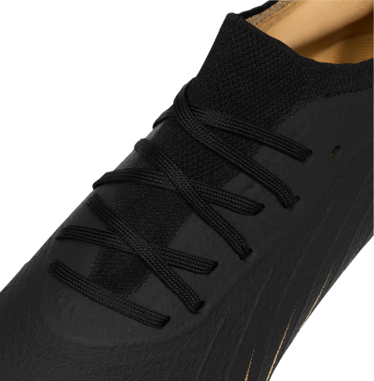 Close-up of the Canterbury Speed Falcon Team SG - Black rugby boot by Canterbury, showcasing black laces, a mesh tongue, and a subtle textured upper design.