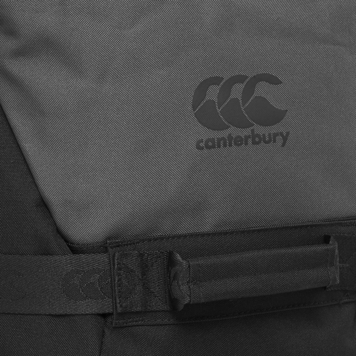 Close-up of the Canterbury Team Wheelie Bag in black, featuring the iconic "Canterbury" logo and triple-C emblem on the fabric—making it an ideal training companion for athletes on the go.