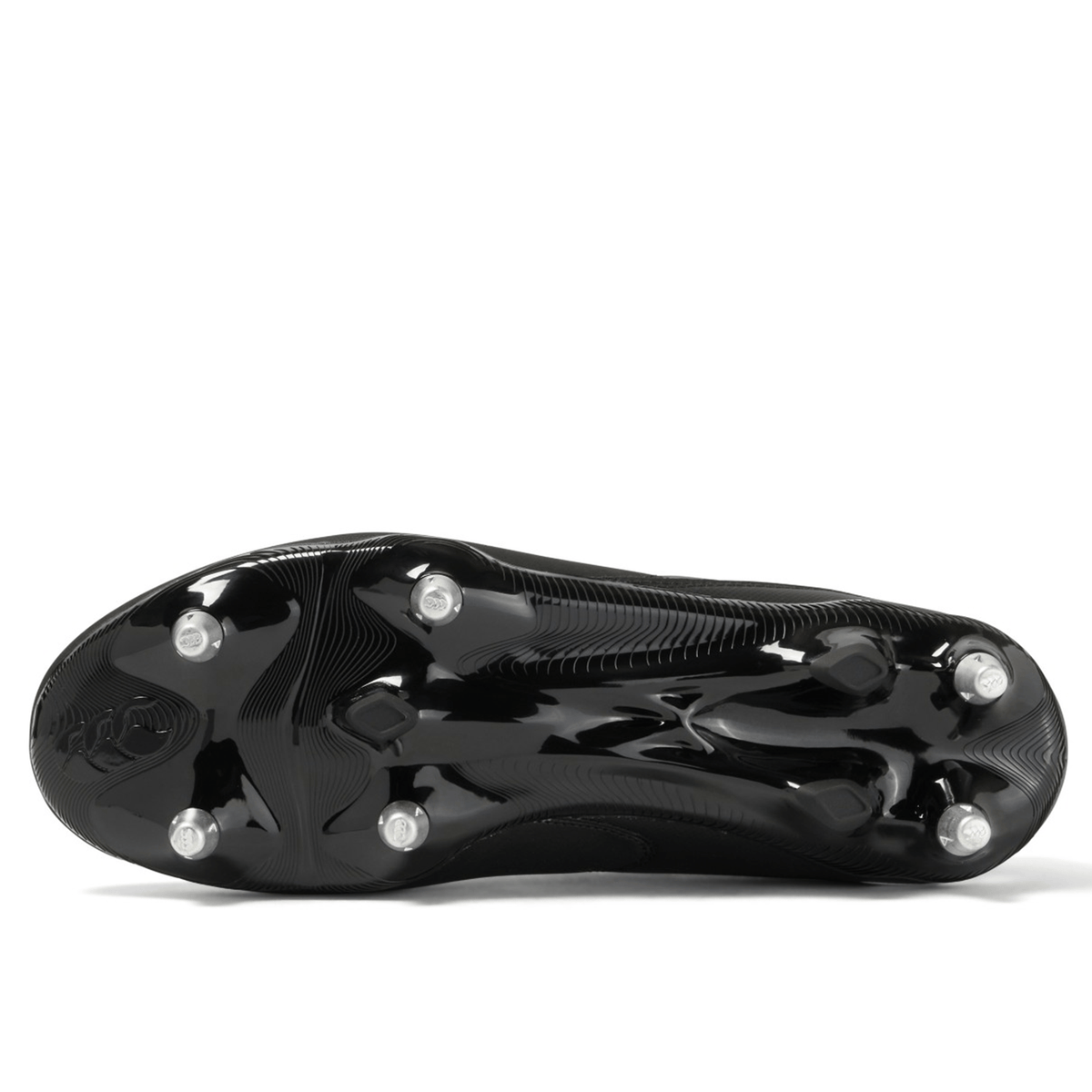 The bottom view of a black and white Canterbury Phoenix Raze SG Boot, featuring high-traction metal studs for optimal performance on soft ground.