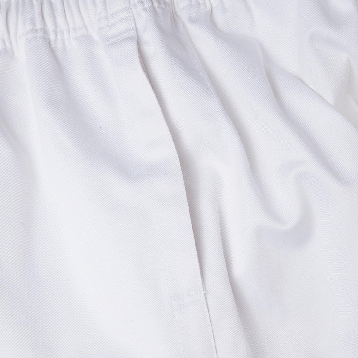 Close-up of Canterbury Professional Cotton Shorts from Bundle Canterbury, featuring a white cotton short with an elastic waistband and stitching detail.